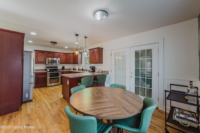 dining space featuring recessed lighting and light wood-style flooring