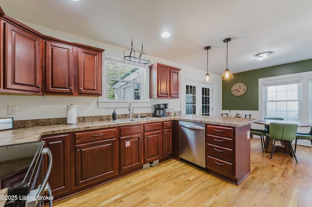 kitchen with a sink, stainless steel dishwasher, a peninsula, and a wealth of natural light
