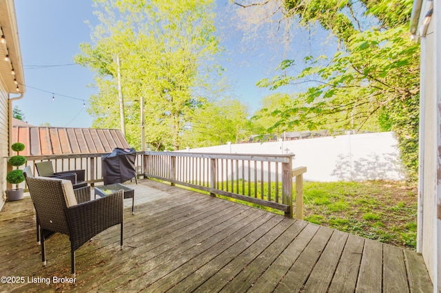 wooden deck featuring a fenced backyard