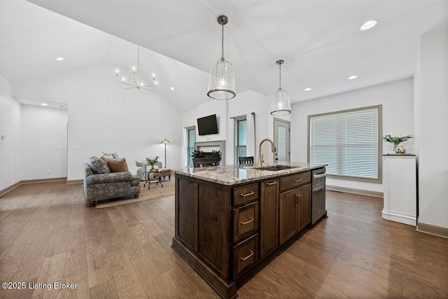 kitchen with dark wood-style flooring, dark brown cabinetry, a sink, and dishwasher