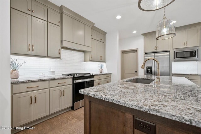 kitchen featuring a sink, appliances with stainless steel finishes, backsplash, and recessed lighting