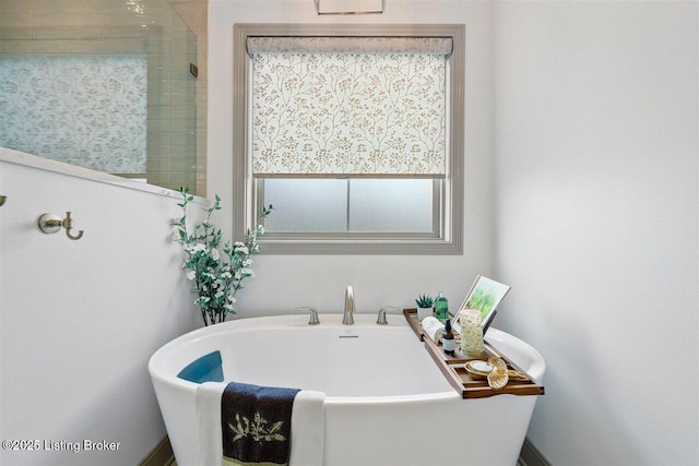 full bathroom with a freestanding bath