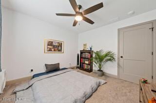 bedroom with a ceiling fan and baseboards