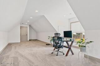 carpeted home office with baseboards and lofted ceiling