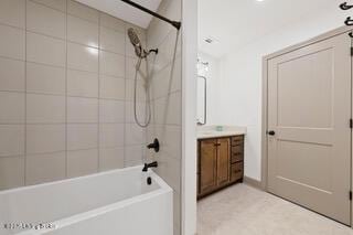 bathroom with shower / washtub combination and vanity
