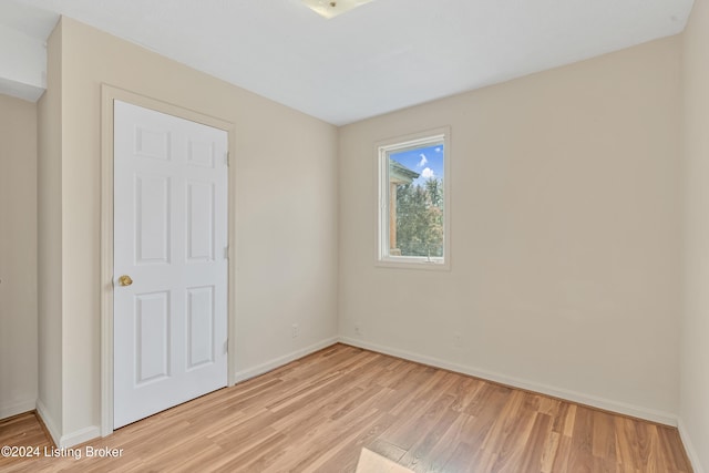 unfurnished bedroom featuring baseboards and light wood-style flooring