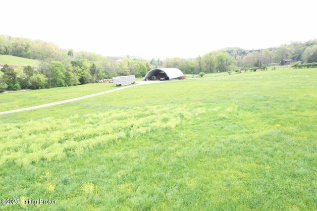 view of yard with a rural view and a carport