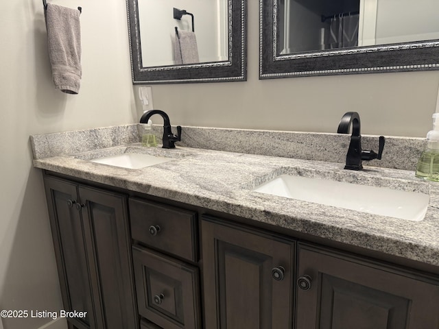 full bathroom featuring double vanity and a sink