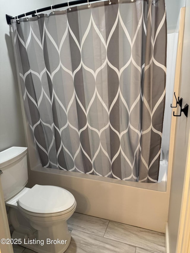 full bathroom with toilet and shower / bath combination with curtain