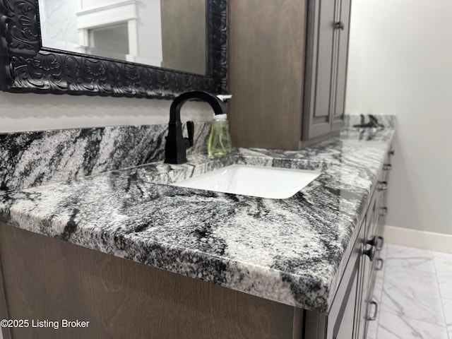 room details featuring baseboards and vanity
