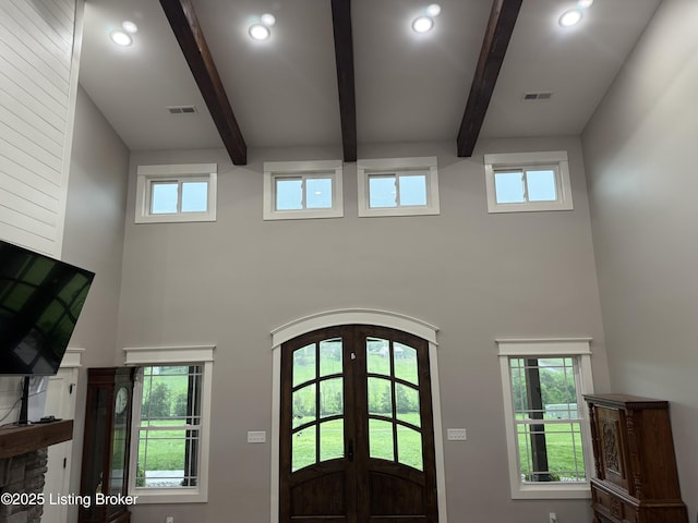 entryway with a towering ceiling, french doors, recessed lighting, and beamed ceiling