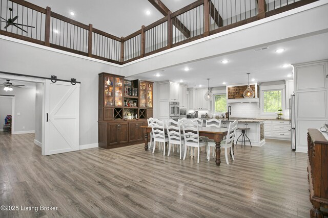 501 Shumate Ln, Bardstown, KY 40004 - dining area with a towering ceiling, ceiling fan, baseboards, wood finished floors, and a barn door