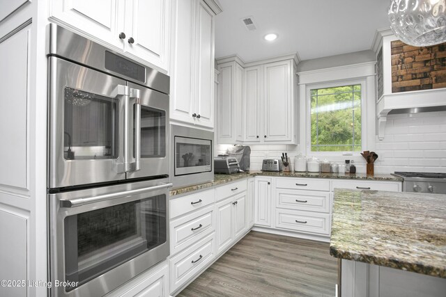 501 Shumate Ln, Bardstown, KY 40004 - kitchen featuring backsplash, white cabinetry, stone countertops, stainless steel appliances, and recessed lighting