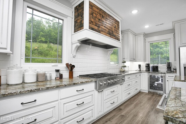 501 Shumate Ln, Bardstown, KY 40004 - kitchen featuring stainless steel gas stovetop, beverage cooler, wood finished floors, decorative backsplash, and light stone countertops