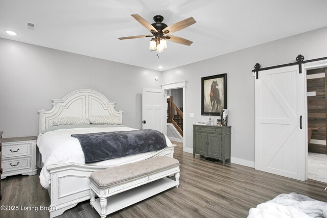 501 Shumate Ln, Bardstown, KY 40004 - bedroom with a barn door, recessed lighting, wood finished floors, baseboards, and a ceiling fan