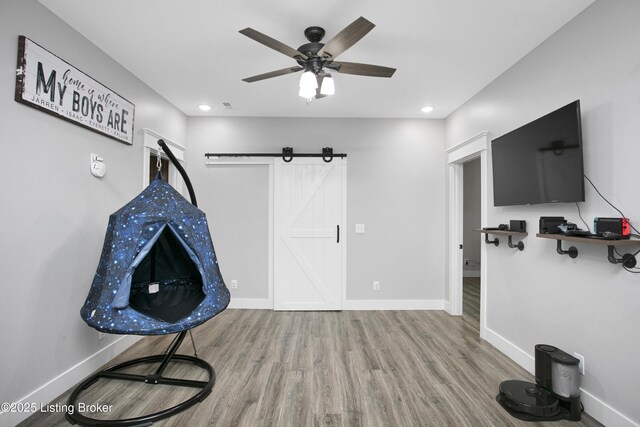 501 Shumate Ln, Bardstown, KY 40004 - unfurnished room featuring wood finished floors, ceiling fan, a barn door, baseboards, and recessed lighting