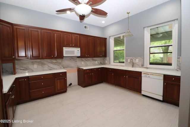 kitchen with white appliances, a ceiling fan, visible vents, backsplash, and pendant lighting