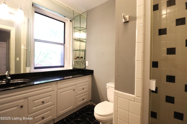 full bath featuring walk in shower, toilet, vanity, and marble finish floor