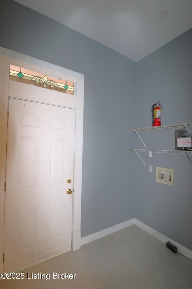 laundry room with baseboards, washer hookup, and laundry area