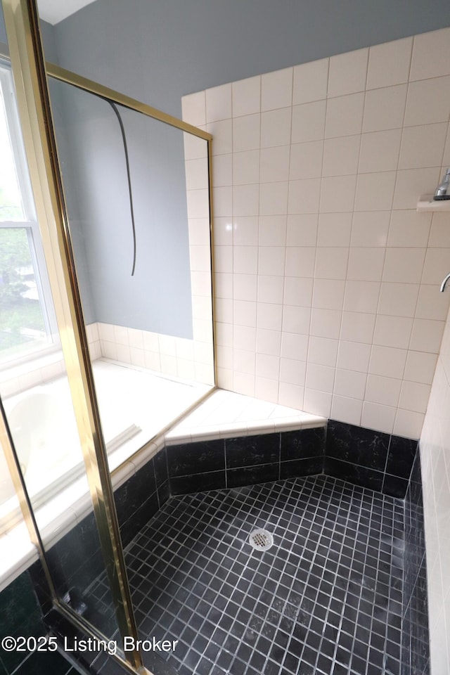 bathroom featuring a tile shower and tiled tub