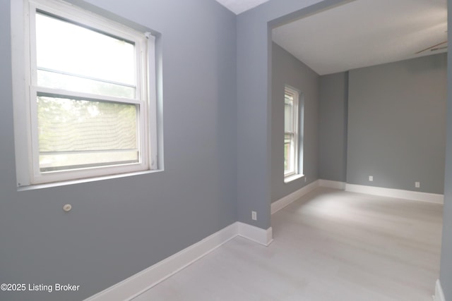 spare room with wood finished floors and baseboards