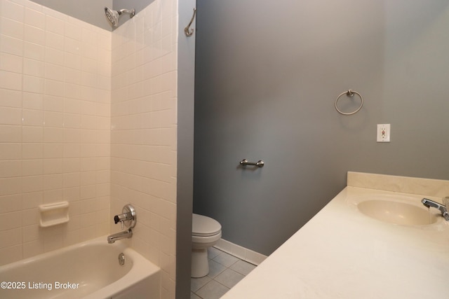 bathroom with tile patterned floors, toilet,  shower combination, and a sink