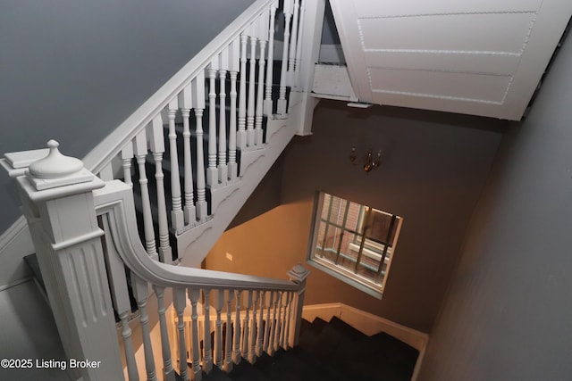 staircase featuring baseboards