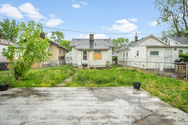 rear view of property featuring a patio area and a fenced backyard