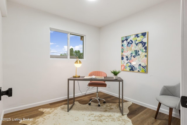 office area with baseboards and wood finished floors