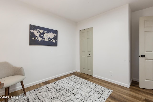 interior space with baseboards and wood finished floors