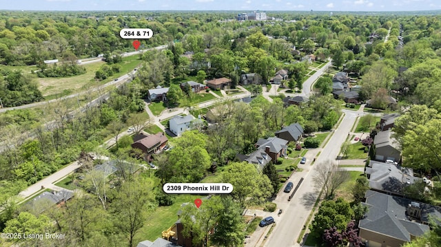bird's eye view featuring a residential view and a wooded view