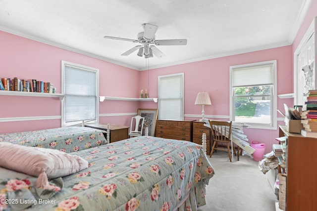 bedroom featuring ceiling fan, crown molding, and carpet flooring