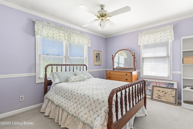 carpeted bedroom featuring baseboards, ornamental molding, ceiling fan, and multiple windows