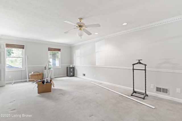 interior space featuring baseboards, visible vents, ceiling fan, and crown molding