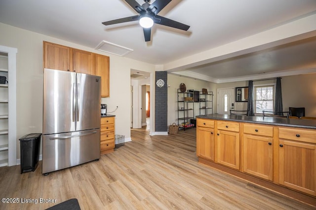 kitchen with light wood-style flooring, freestanding refrigerator, dark countertops, baseboards, and a ceiling fan