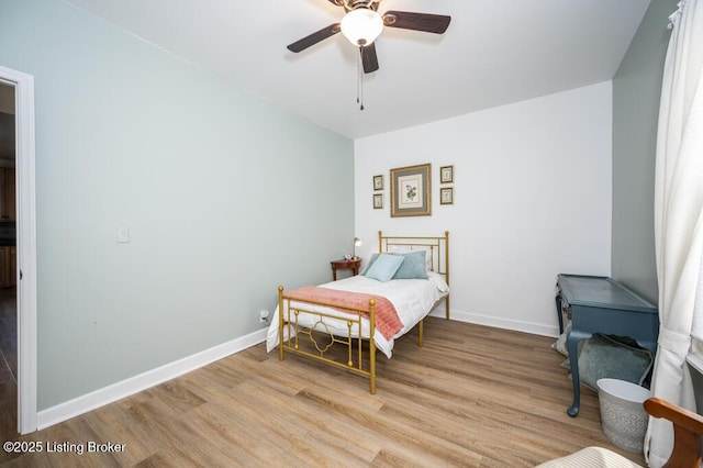 bedroom with baseboards, wood finished floors, and ceiling fan