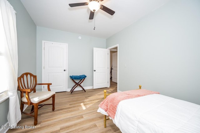 bedroom with a ceiling fan and light wood-type flooring