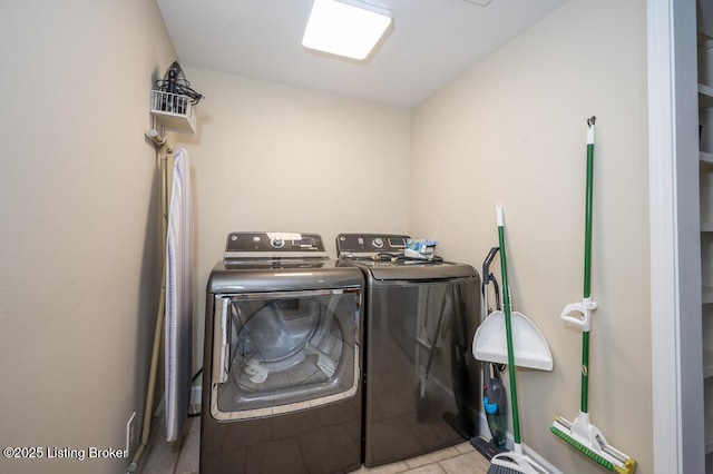 washroom featuring washing machine and clothes dryer and laundry area