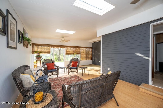 interior space with an outdoor hangout area, a skylight, and a ceiling fan