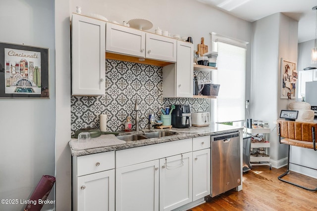kitchen featuring open shelves, tasteful backsplash, wood finished floors, and dishwasher