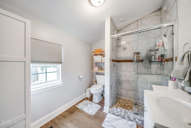full bathroom featuring toilet, baseboards, vaulted ceiling, and a shower stall