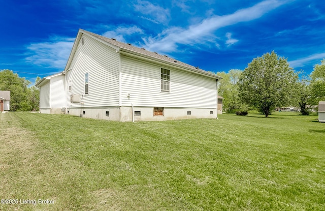 rear view of house featuring a yard and crawl space