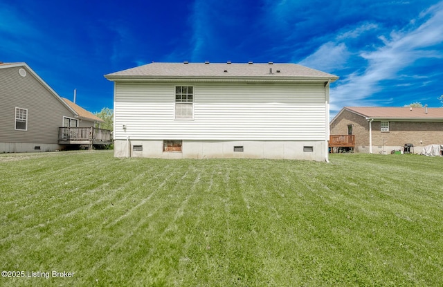 rear view of house featuring a lawn, a deck, and crawl space