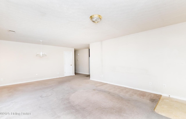 empty room with baseboards and light colored carpet