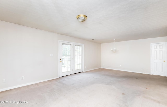 empty room with baseboards and light carpet