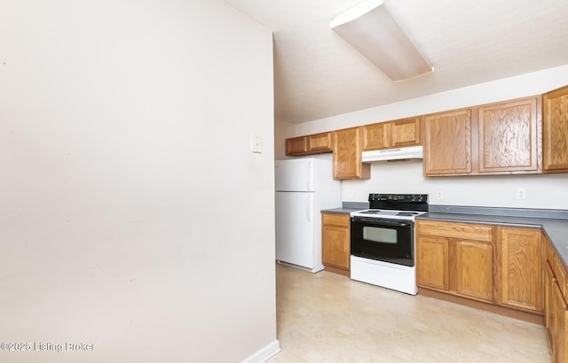 kitchen with dark countertops, electric range oven, brown cabinetry, freestanding refrigerator, and under cabinet range hood