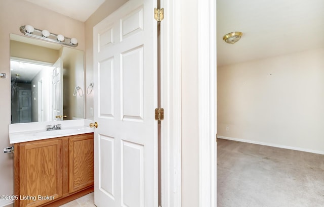 bathroom with vanity and baseboards