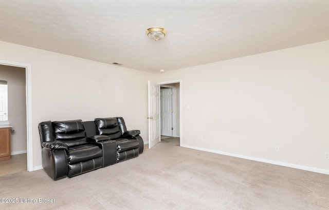 living area featuring baseboards, light colored carpet, and visible vents