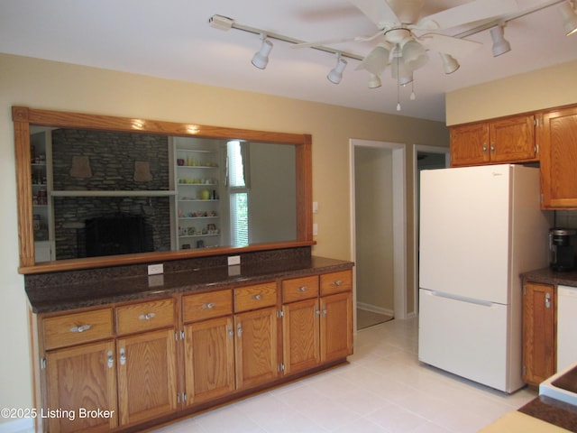 11802 Running Creek Rd, Douglass Hills, KY 40243 - kitchen featuring freestanding refrigerator, rail lighting, brown cabinetry, a ceiling fan, and light tile patterned floors