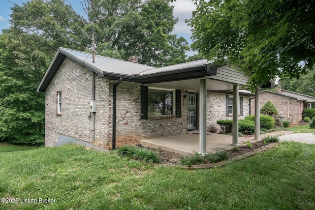 4217 Deckard School Rd, Radcliff, KY 40160 - view of home's exterior featuring a lawn, metal roof, and brick siding